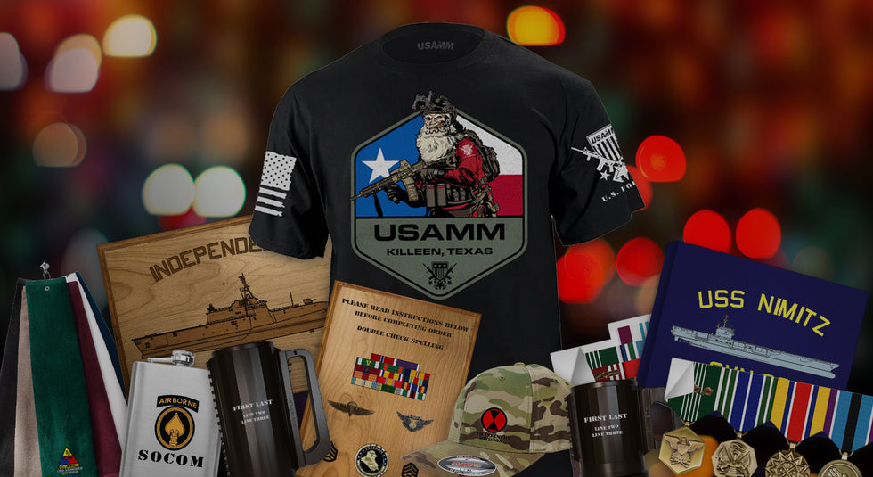 USAMM's Patriotic Shirts & Apparel with military-themed gifts, plaques, and memorabilia against a festive, blurred light background.