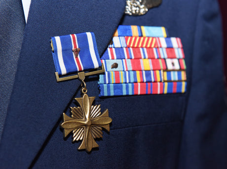 An Airman wears the Distinguished Flying Cross with a Valor device.