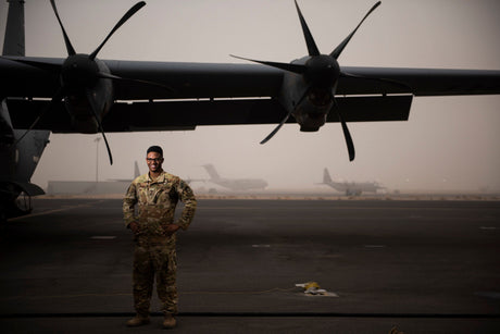 An Airman under the wing of a C-130.