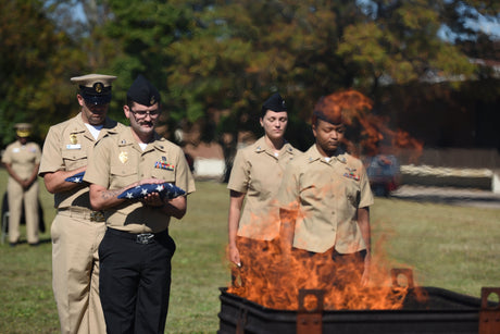 Navy personnel participate in a flag retirement ceremony.