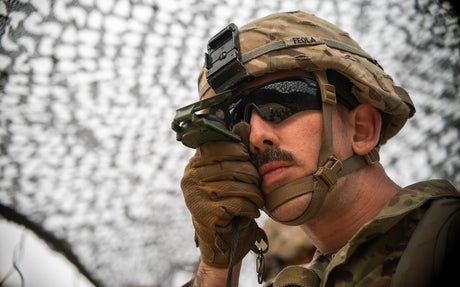 A U.S. Army soldier shoots an azimuth on his compass.
