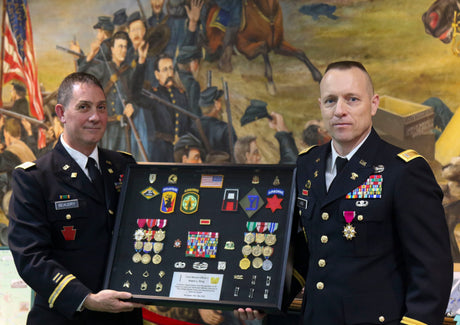 An Army officer is presented a shadow box.