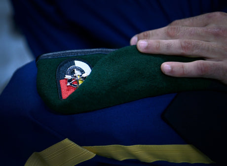 A Special Forces soldier awaits to don his green beret.