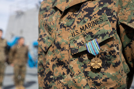 A Marine stands in formation after being pinned with a medal.
