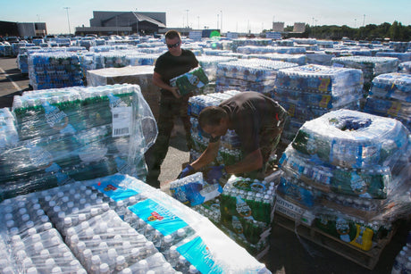 Services members stack water during Hurricane Katrina.