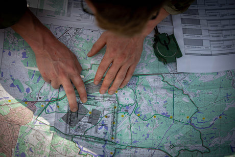 A service member learns how to use a compass.