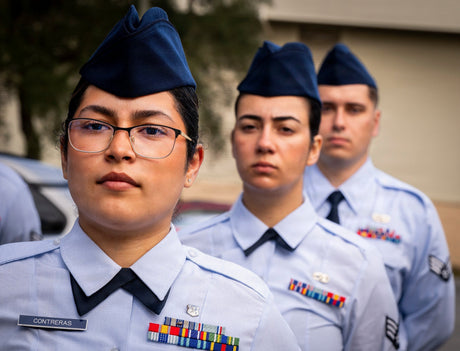 Airmen stand at attention awaiting inspection.