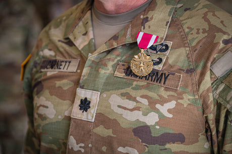 An officer receives an end of tour medal.