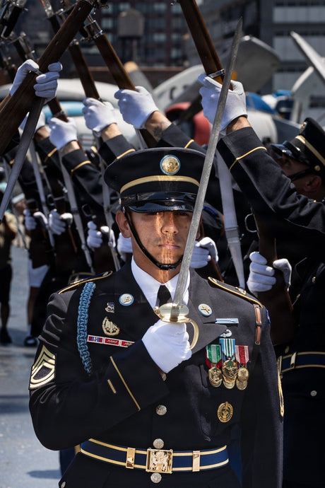 An Army soldier salutes with his sword.