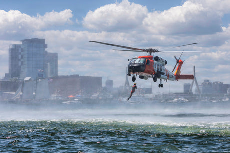 A rescue swimmer jumps into the ocean.