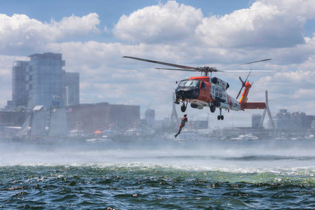 A rescue swimmer jumps into the ocean.