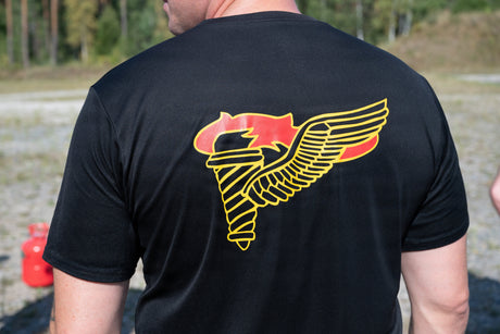 An instructor at the Pathfinder course wears a Pathfinder badge shirt.