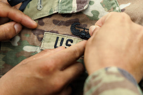 A soldier is pinned with their Air Assault wings.