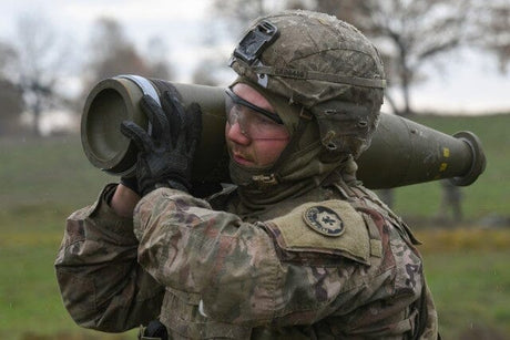 An Army artilleryman loads munitions.