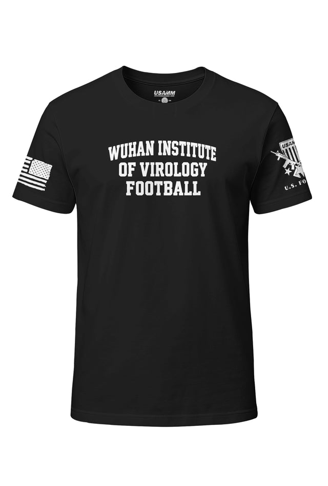A black short-sleeve t-shirt with 'WUHAN INSTITUTE OF VIROLOGY FOOTBALL' printed in white block letters on the chest. The left sleeve features a distressed American flag graphic, and the right sleeve features a U.