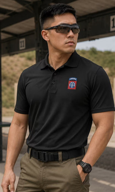 Custom Polo Builder - man in a black polo with an embroidered unit patch at a shooting range.