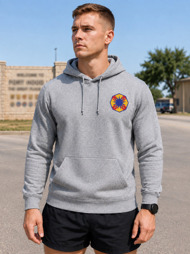 Soldier in a grey unit hoodie with an embroidered unit crest on the left chest.